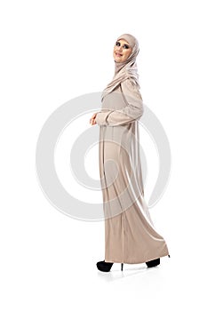 Beautiful arab woman posing in stylish hijab isolated on studio background. Fashion concept