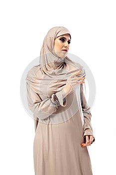 Beautiful arab woman posing in stylish hijab isolated on studio background. Fashion concept