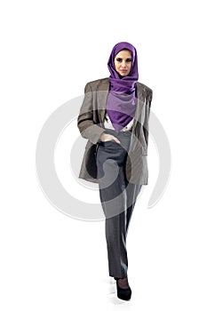 Beautiful arab woman posing in stylish office attire isolated on studio background. Fashion concept