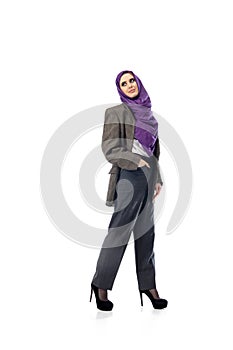 Beautiful arab woman posing in stylish office attire isolated on studio background. Fashion concept