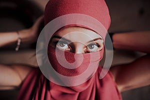 Beautiful arabic woman in red hijab with bright makeup