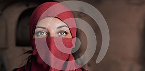 Beautiful arabic woman in red hijab with bright makeup