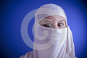 Beautiful arabic woman with traditional veil on her face, intens