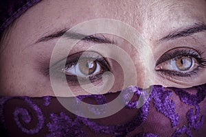 Beautiful arabic woman with traditional veil on her face, intens