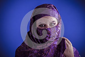 Beautiful arabic woman with traditional veil on her face, intens