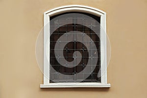 Beautiful arched window with grills in building outdoors