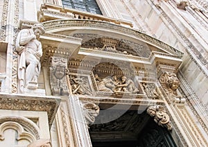 Beautiful architectural details, bas-reliefs and sculptures of the entrance to the Milan Cathedral Duomo di Milano. Italy