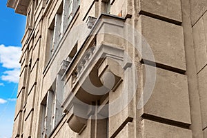 Beautiful architectural structure with an old stone balcony on the wall of an antique house in the city against the backdrop of a