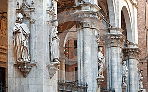Beautiful architecture of the 15th century Loggia della Mercanzia with columns, sculptures and reliefs in Siena, Italy.
