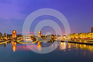 Beautiful architecture building and colorful bridge in twilight