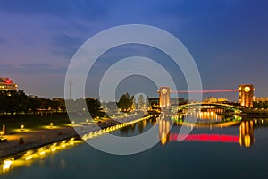 Beautiful architecture building and colorful bridge in twilight