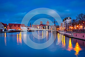 Beautiful architecture of Gdansk old town reflected in the Motlawa river at dawn, Poland