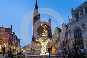 Beautiful architecture of the old town in Gdansk with Neptune fountain at dawn, Poland