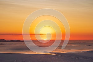 Beautiful Arctic sunset. Scenic colorful sky at dawn. Aerial view. Sunrise bright sky with White Sea. Top View from high altitude