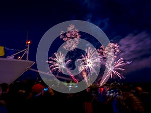 Beautiful Armada fireworks glowing over the Seine river with one big boat crowding the water and the dock