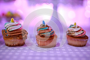 Beautiful arrangements of colorful cup cakes on a table on a baptism day