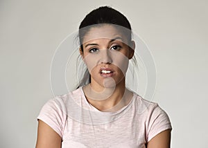 Beautiful arrogant and moody Mexican woman showing negative feeling and contempt facial expression