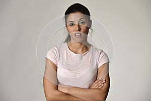 Beautiful arrogant and moody spanish woman showing negative feeling and contempt facial expression