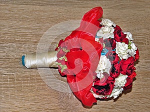 Beautiful artificial flower bouquet on a wooden surface