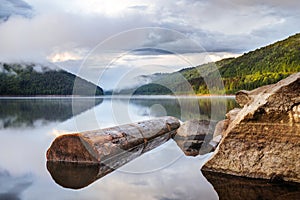 Mirror smooth water of the carpathian Zetelaka lake. Beautyful landscape after rain