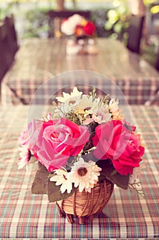 Beautiful artificial roses on table