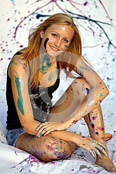 Beautiful artist covered in paint