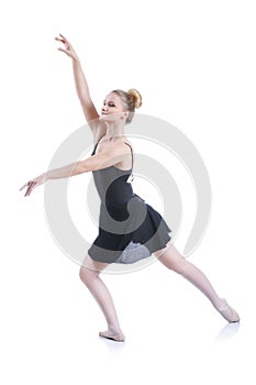 Beautiful artistic female ballerina working out, performing ballet element