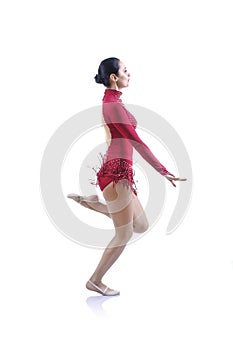 Beautiful artistic female gymnast working out, performing gymnastics element