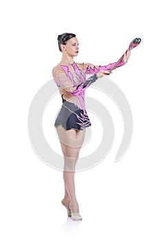 Beautiful artistic female gymnast working out, performing gymnastics element