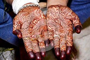 Beautiful artwork of Henna Mehndi on fair hands of indian groom