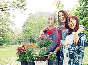 Beautiful Asia three Woman Gardeners family are growing flowers in pots.