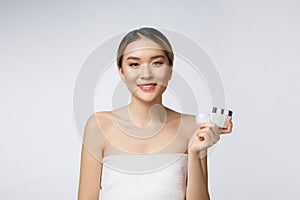 Beautiful Asia woman presenting product on white background. COPY SPACE.