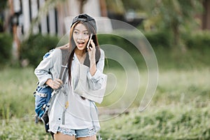 Beautiful Asia woman traveler talking with smart phone
