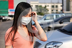 Beautiful asia woman wearing mouth mask against air smog pollution PM 2.5 and Coronavirus in the community,bangkok thailand