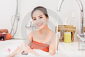 Beautiful Asian beauty woman in bath with rose petal. body care and Spa