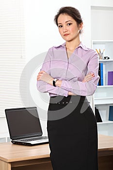 Beautiful Asian business woman standing in office photo