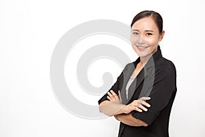 Beautiful Asian business woman wearing black suit with her crossed arms on white background and copy space.  Confident Asian