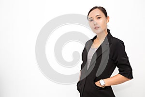 Beautiful Asian business woman wearing black suit with her hand in suit pocket on  white background and copy space. Confident