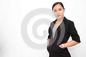 Beautiful Asian business woman wearing black suit with her hand in suit pocket on  white background and copy space. Confident