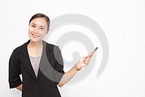 Beautiful Asian business woman wearing black suit holding a pen pointing presenting something on  white background and copy space