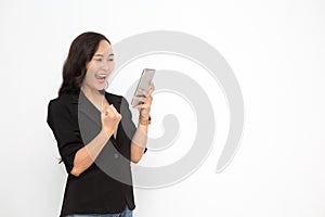Beautiful Asian business woman wearing black suit holding smartphone on white background and copy space.  Confident Asian working