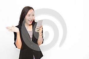 Beautiful Asian business woman wearing black suit holding smartphone on white background and copy space.  Confident Asian working