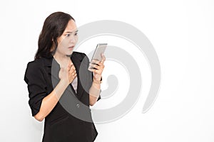 Beautiful Asian business woman wearing black suit holding smartphone on white background and copy space.  Cute Asian working woman