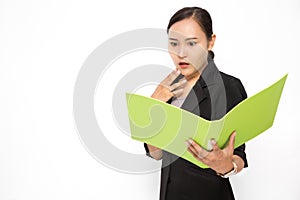 Beautiful Asian business woman wearing black suit look at document folder and shocked with something on white background and copy