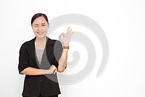 Beautiful Asian business woman wearing black suit okay sing presenting something on  white background and copy space. Confident