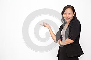 Beautiful Asian business woman wearing black suit presenting something on  white background and copy space. Confident Asian