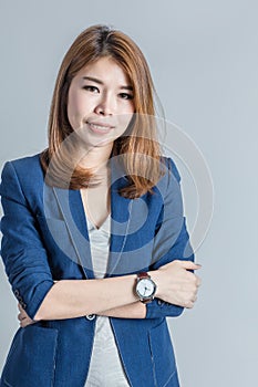 Beautiful asian businesswomanwith cute smile isolated on grey ba
