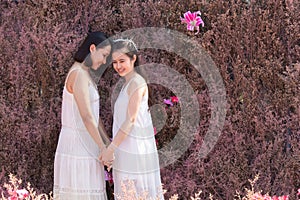 Beautiful Asian couple with wedding dress LGBT women spent time together in park  homosexual announcement relationship for social