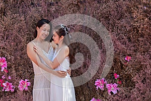 Beautiful Asian couple with wedding dress LGBT women spent time together in park  homosexual announcement relationship for social