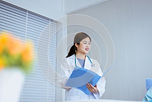 Beautiful asian doctor woman working auscultate or patient examination at hospital photo